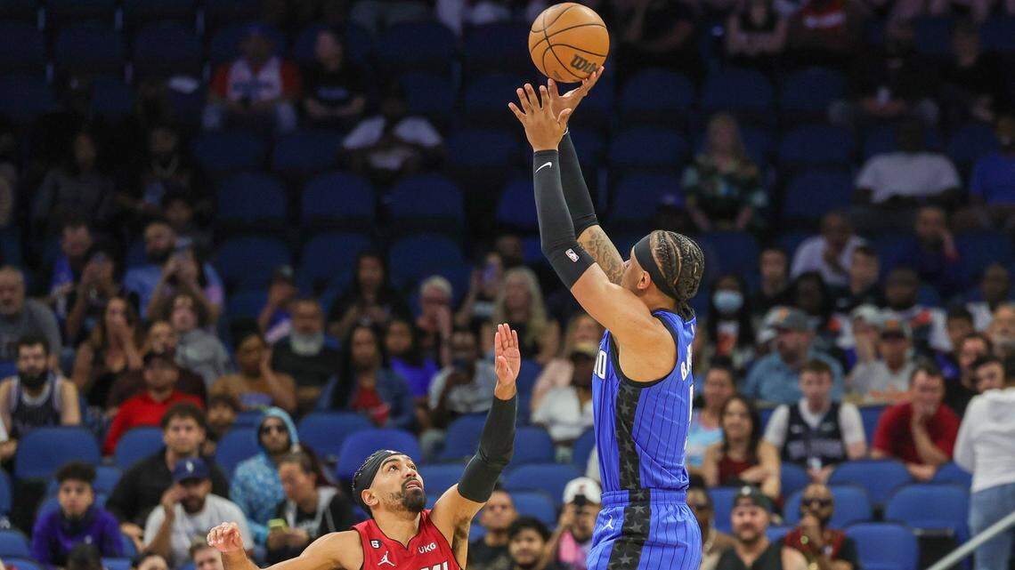 Orlando Magic forward Paolo Banchero (5) shoots the ball over Miami Heat guard Gabe Vincent (2) during the first quarter at Amway Center.
