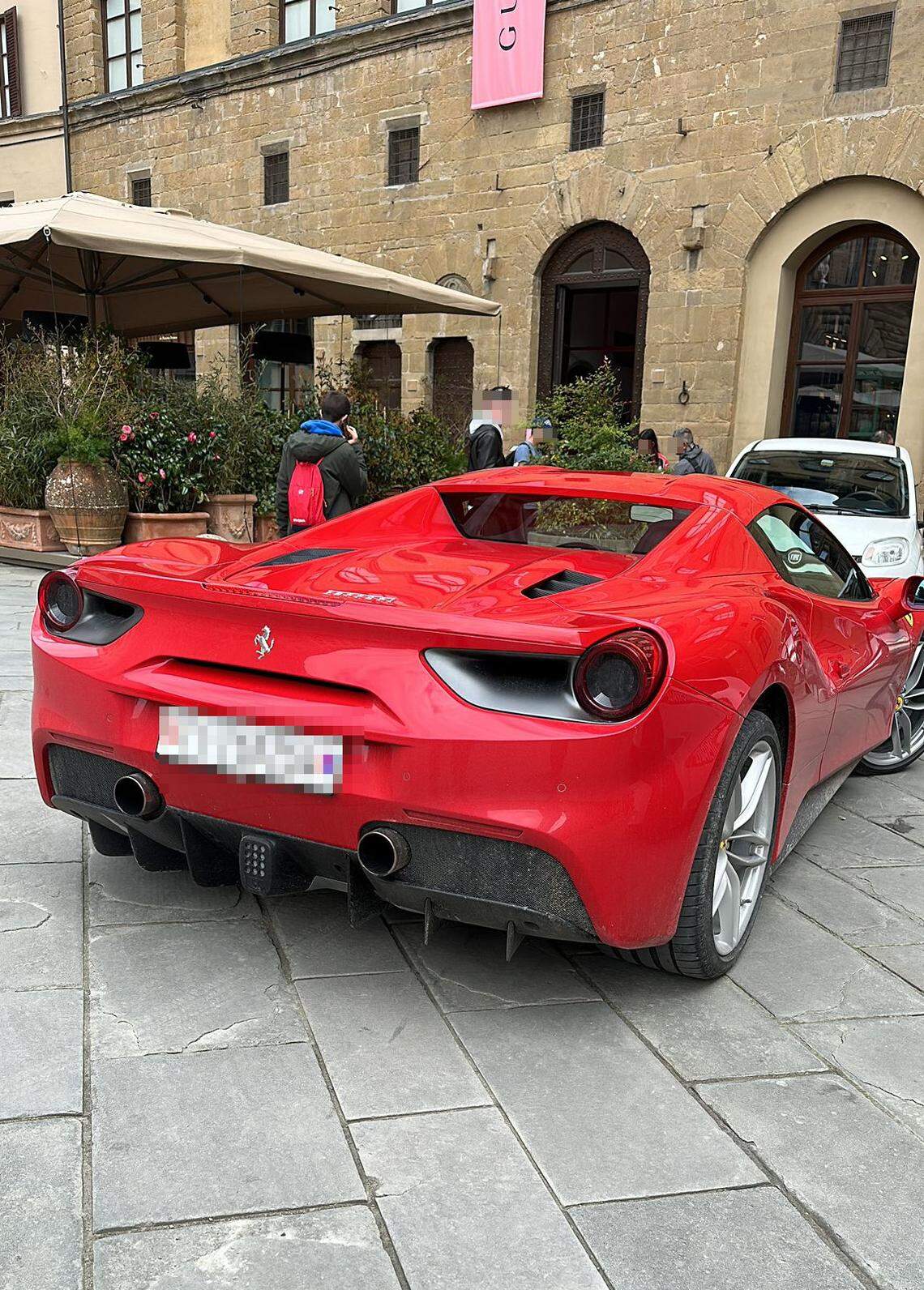 The red Ferrari driven by the tourist.