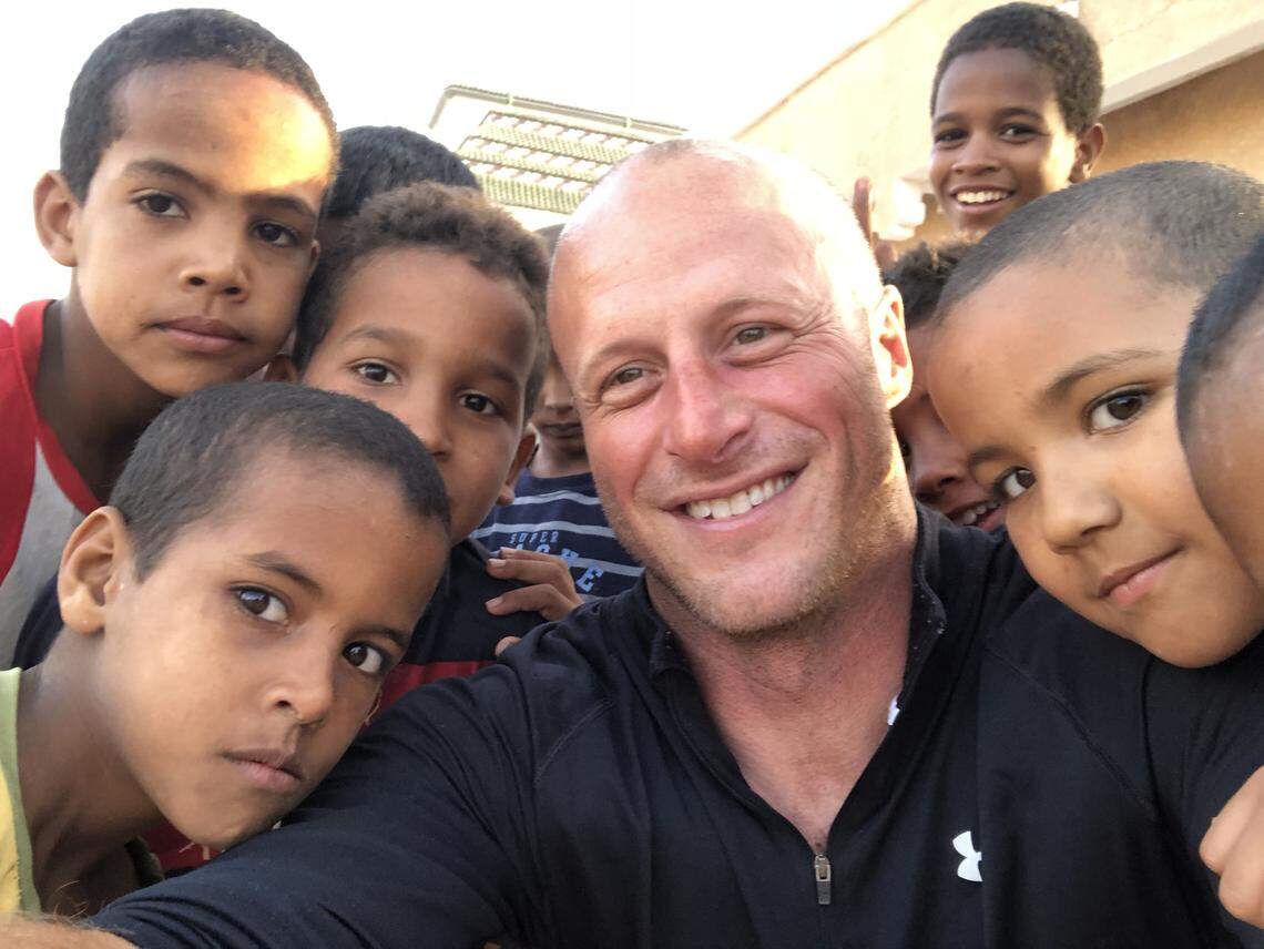 Former Guantánamo guard Steve Wood hanging out with young relatives of Mohamedou Ould Slahi in Nouakchott, Mauritania, on May 17, 2018 during a three-day reunion with his former prisoner. The boy on Wood's shoulder to the right was Slahi's nephew Salim, who feared the 6-foot-2-inch former U.S. Army sergeant was there to take his uncle back to prison. So the two men said Wood made friends with the kids through pickup soccer.