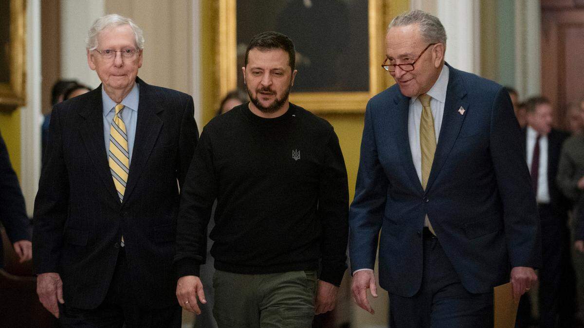 Ukrainian President Volodymyr Zelenskyy, center, is escorted by Senate Minority Leader Mitch McConnell, R-Ky., left, and Senate Majority Leader Chuck Schumer, D-N.Y., as he visits the Capitol on Dec. 12 to issue a plea for Congress to approve continued wartime funding.