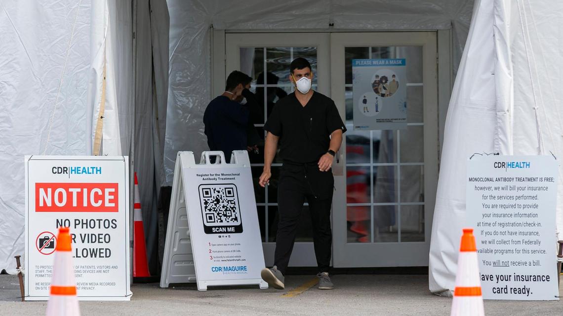 A worker outside a monoclonal antibody treatment site for COVID-19 at Miami Dade College North Campus in Miami, Florida, on Wednesday, Jan. 19, 2022.