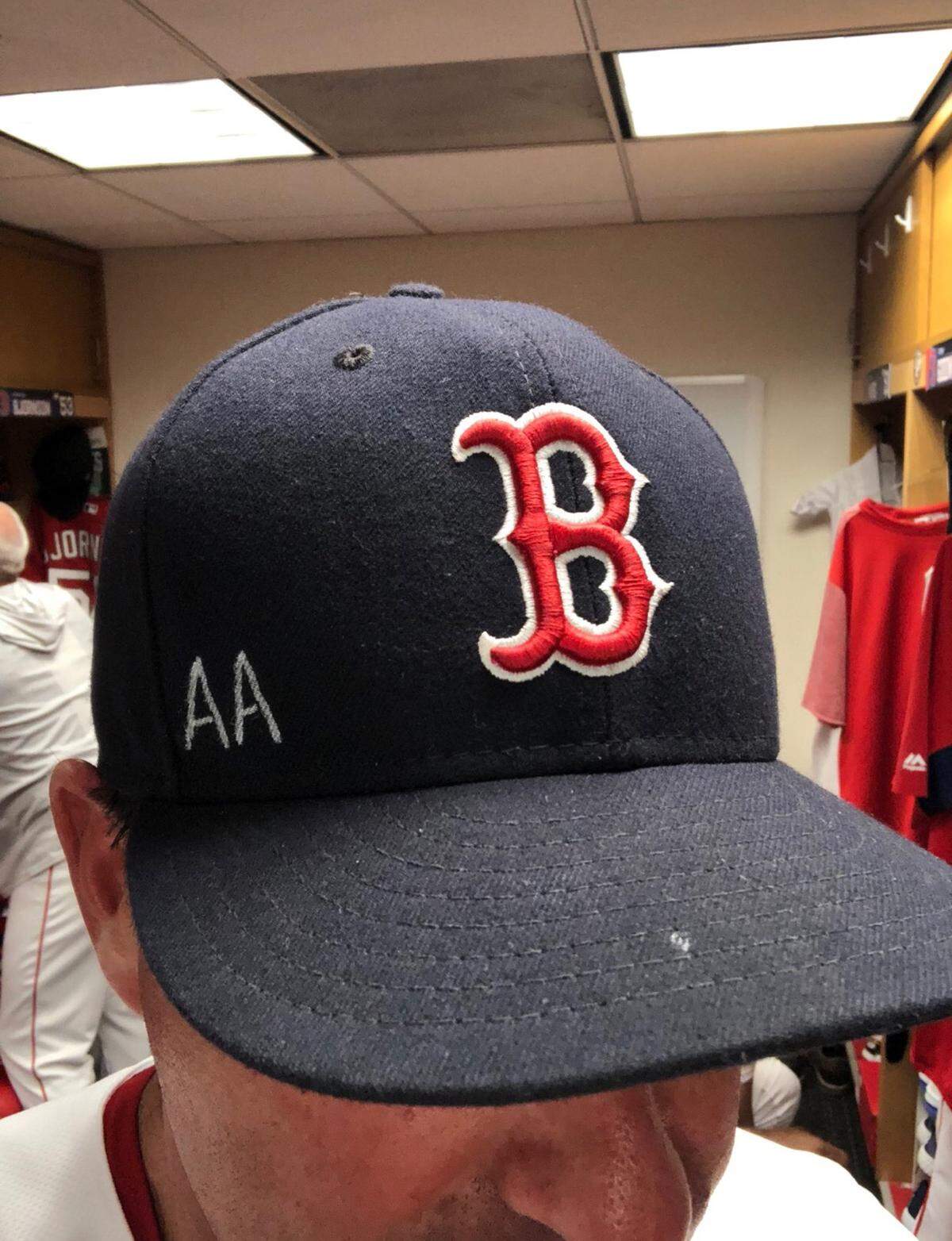 Red Sox assistant hitting coach Andy Barkett, manager Alex Cora and mental skills coach Laz Gutierrez wore caps with the initials A.A. on it during Sunday’s game.