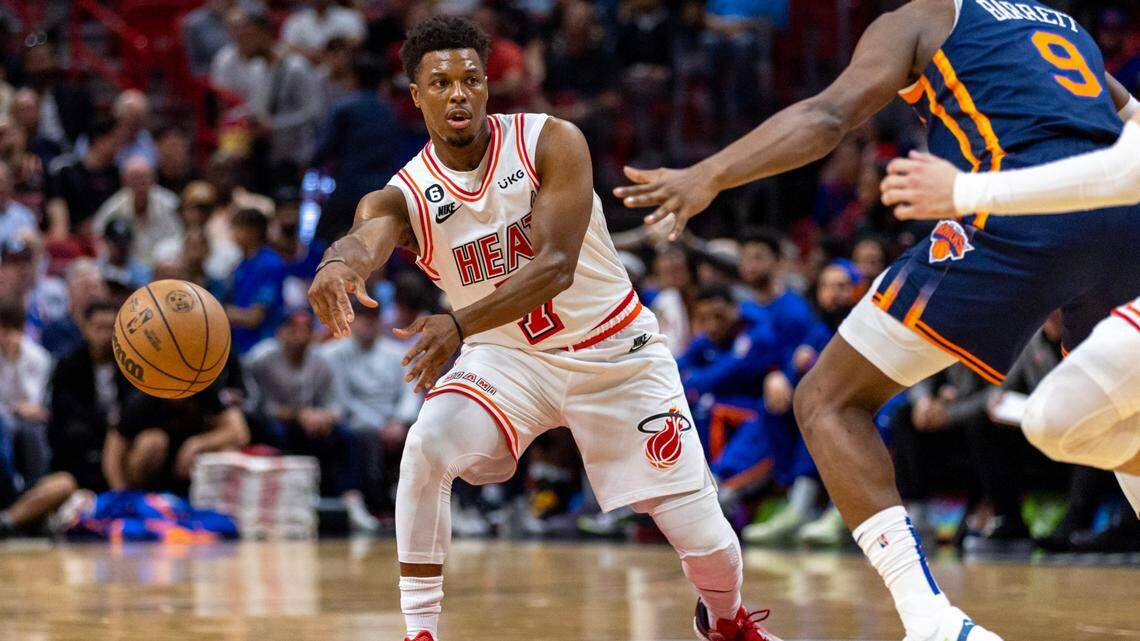 Miami Heat point guard Kyle Lowry (7) passes the ball around New York Knicks guard RJ Barrett (9) during the first half of an NBA game at Miami-Dade Arena in Downtown Miami on March 22, 2023.
