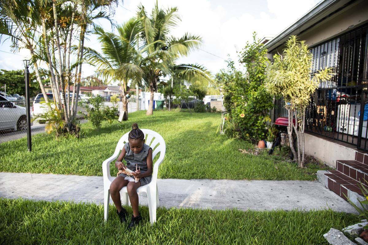 Zeevah Venord, 8, plays outside of her Miami home. Zeevah’s mother, Sherry Hunt, advocated for a new state law that allows women in abusive situations to receive unemployment benefits to help them leave their abuser. Florida Gov. Ron DeSantis signed the new law, which went into effect July 1.