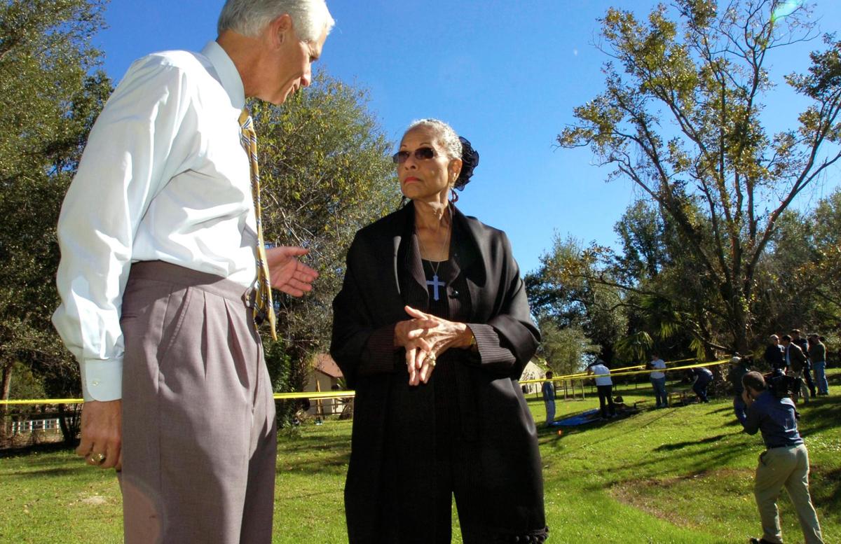 In this AP file photo, Florida Attorney Gen. Charlie Crist, left, speaks with Evangeline Moore, daughter of civil rights leaders Harry T. and Harriette V. Moore, as the two pause during a walk on the grounds of the Moore family home in Mims, Fla., Friday, Dec. 2, 2005. Four Ku Klux Klan members so violent they were kicked out of the white supremacist group in Georgia are almost certainly to blame for the unsolved 1951 bombing murders of two civil rights activists, investigators said Friday. An excavation is under way and could take from two weeks to four months, depending on how much evidence is recovered. The debris will be examined by the FBI lab in Quantico, Va., Florida Attorney General’s Office investigator Frank Beisler said.