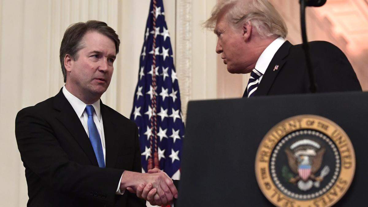 President Donald Trump, right, shakes hands with Supreme Court Justice Brett Kavanaugh, left, before a ceremonial swearing in in the East Room of the White House in Washington, Monday, Oct. 8, 2018.