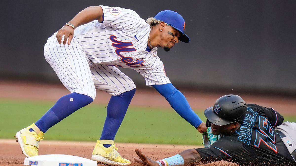 New York Mets’ Francisco Lindor, left, tags out out Miami Marlins’ Jesus Sanchez as he attempts to steal second base during the first inning in the first baseball game of a doubleheader Tuesday, Sept. 28, 2021, in New York.
