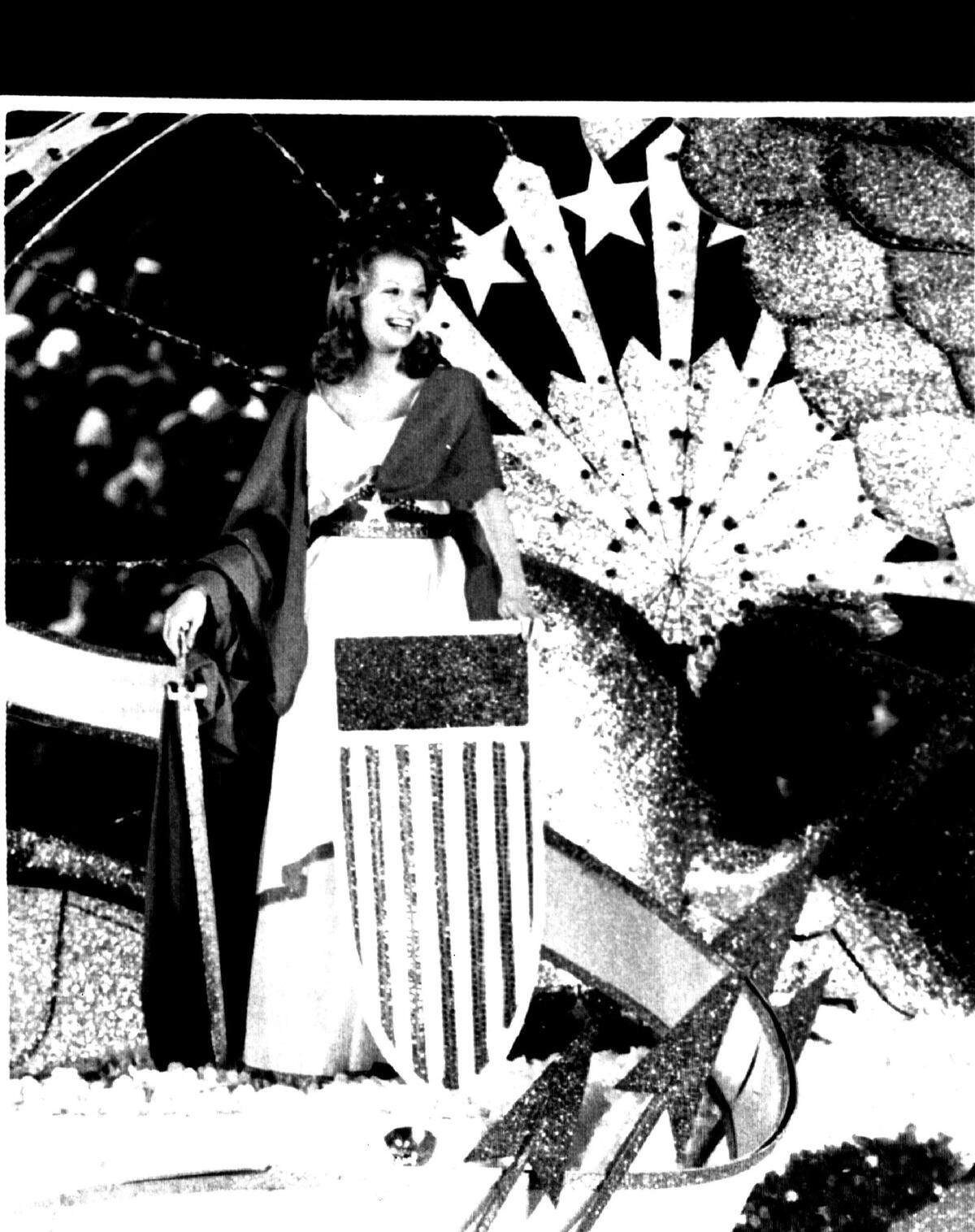In 1976, Orange Bowl Queen Michelle Moore stands on a float at the Orange Bowl Parade in Miami.