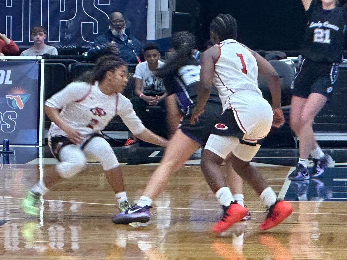 Northeast High girls’ basketball players Jazmine Jones (left) and Nykeria Flowers (right) play defense against Gainesville’s Catalina Giraldo Vergara on Wednesday during a Class 5A state semifinal at the RP Funding Center in Lakeland, Fla.