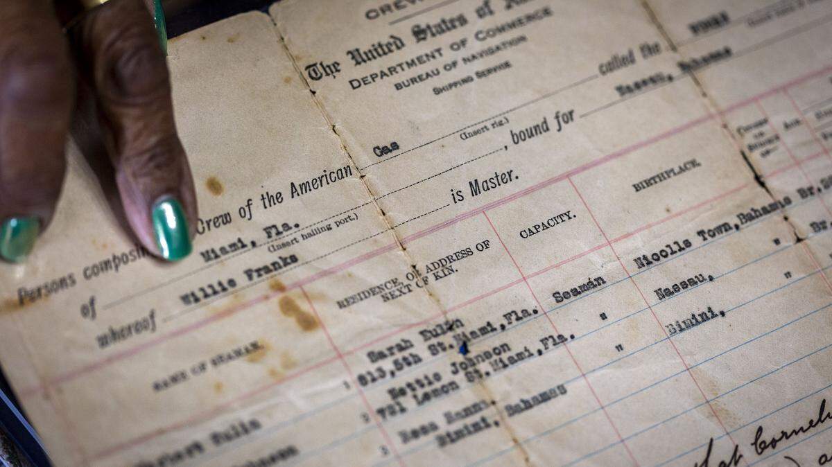 Miami Gardens, FL, October 21, 2025 -  Patricia Braynon, whose family has been in the U.S. since the 1800s, Points to her Grandfather's name in a Ship's Manifest dated 1919 


