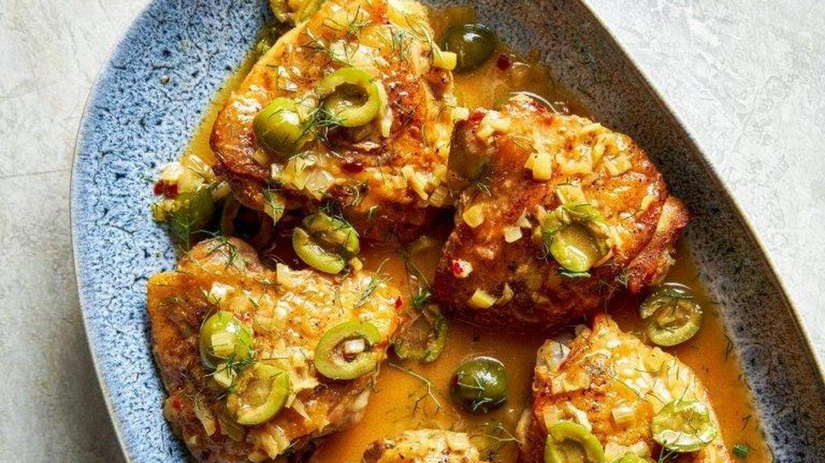 Braised chicken thighs with fennel, orange and olives.