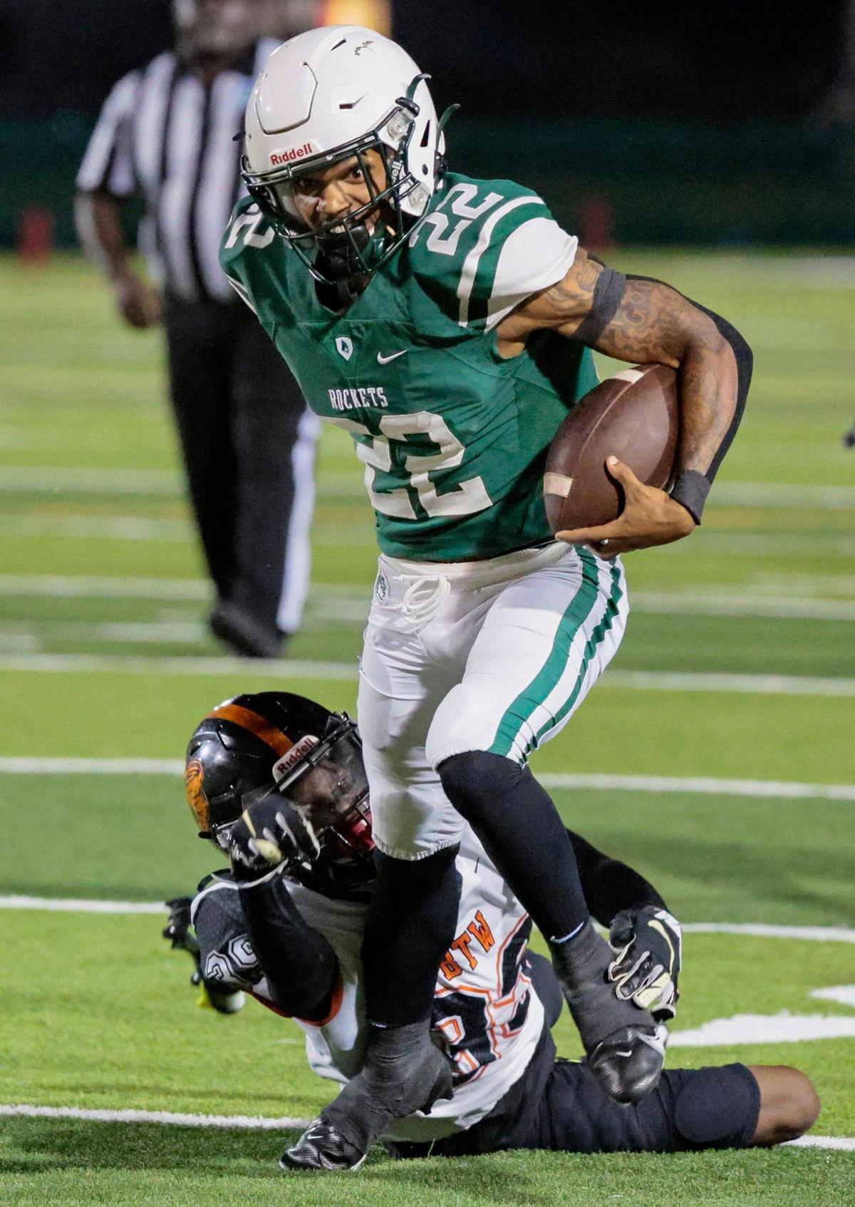 Miami Central Senior High School Rockets running back Jonathan Harris (22) attempts to break a tackle by Booker T. Washington Senior High School defensive back Antonio Branch (39) in the first half at Traz Powell Stadium on Friday, September 9, 2022.