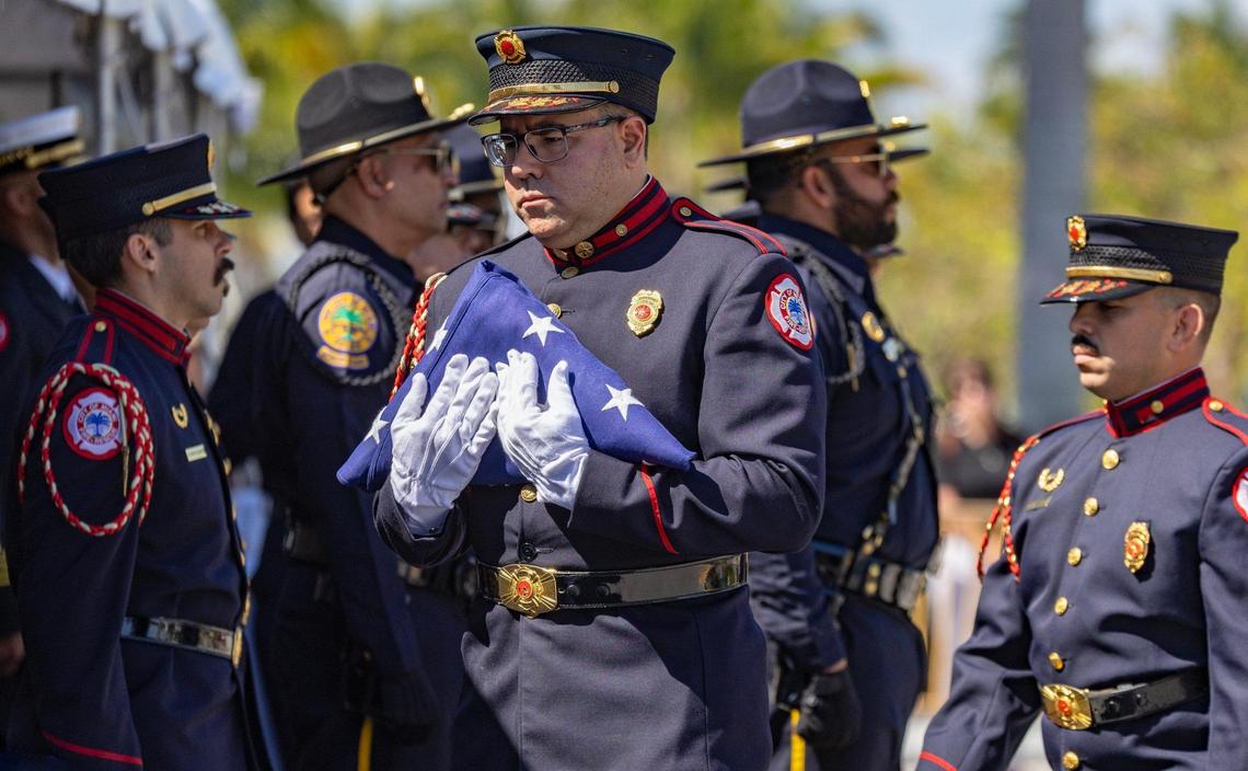 A Miami Fire-Rescue Honor Guard carries a memorial American flag as a memorial service begins for Miami City Commissioner Manolo Reyes at Miami City Hall on Wednesday, April 16, 2025.