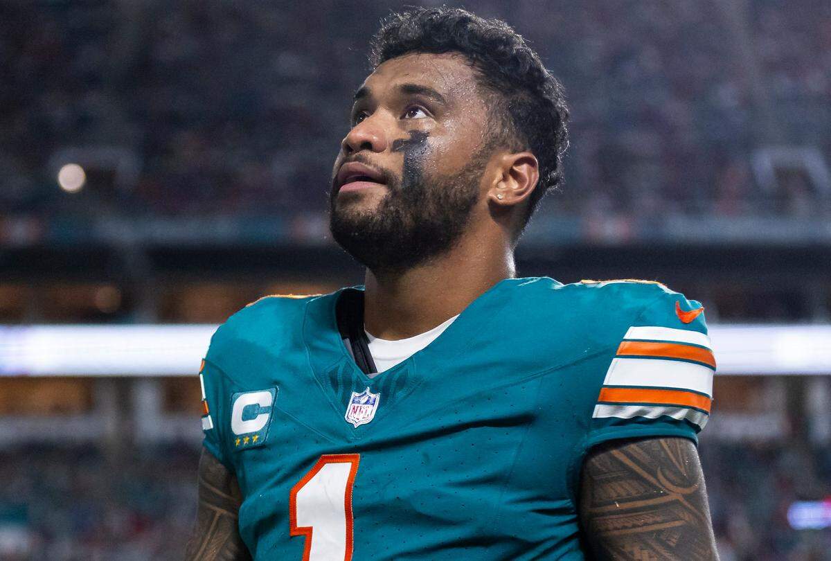 Miami Dolphins quarterback Tua Tagovailoa (1) walks off the field after suffering a concussion in a play against the Buffalo Bills in the second half of their NFL game at Hard Rock Stadium on Thursday, Sept. 12, 2024, in Miami Gardens, Fla.