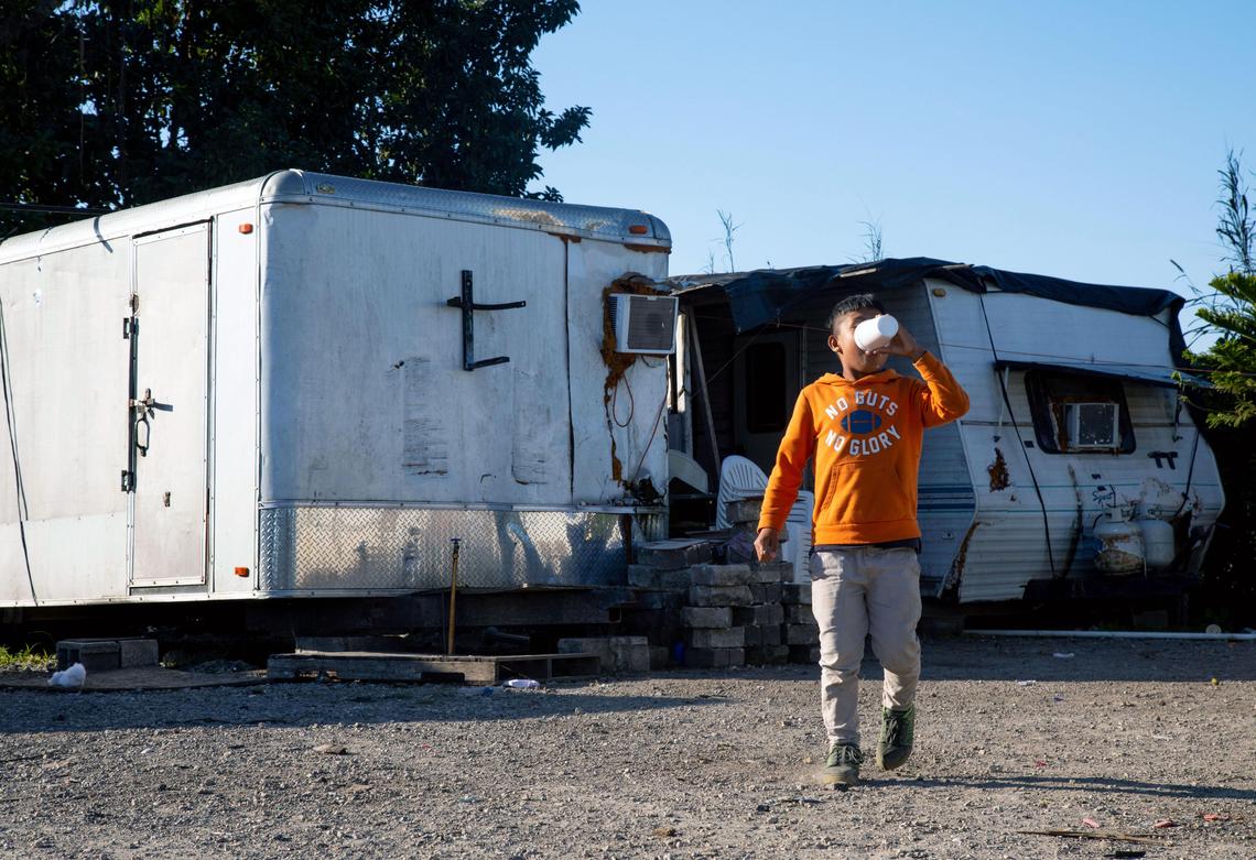 A migrant child walks through a secret camp in South Miami-Dade.
