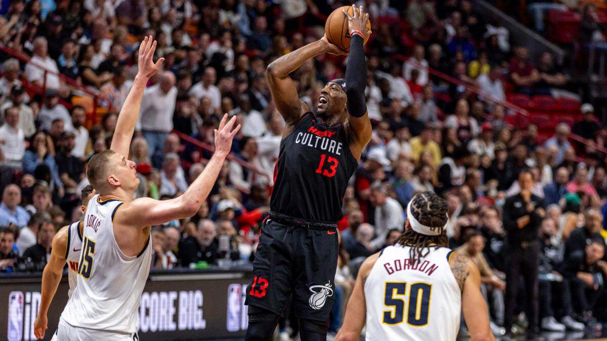 Miami Heat center Bam Adebayo (13) shoots a jump shot over Denver Nuggets center Nikola Jokic (15) during the second half of an NBA game at Kaseya Center in Miami, Florida, on Wednesday, March 13, 2024.