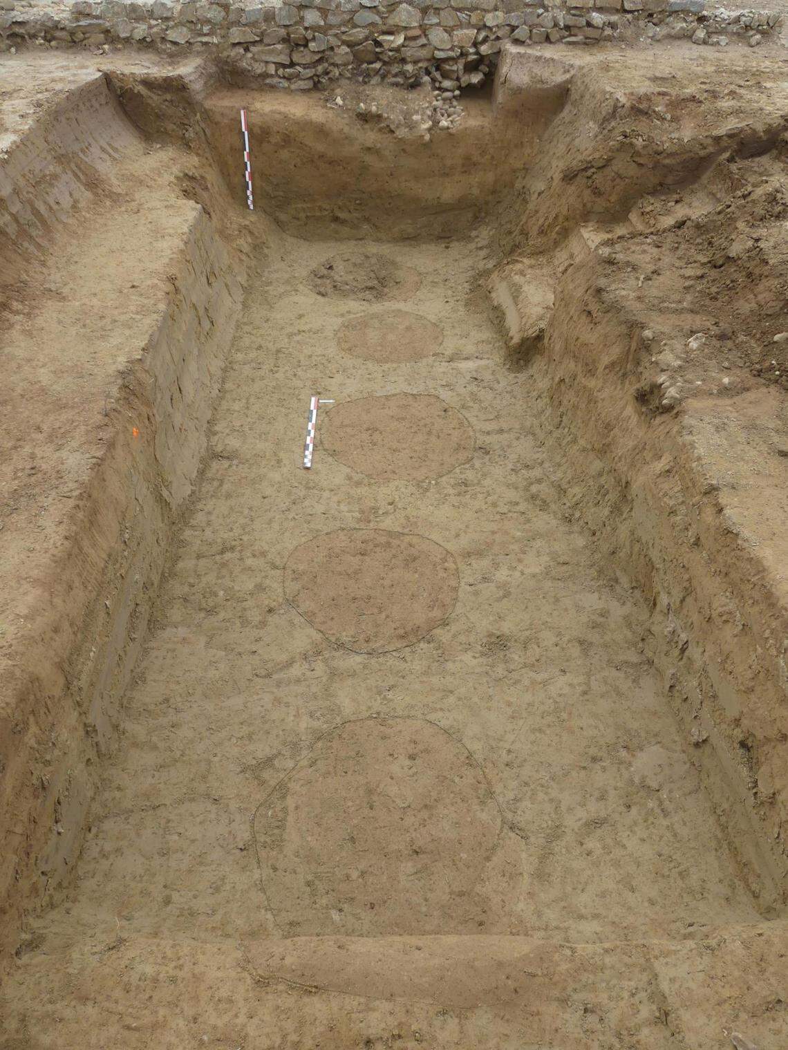 A row of imprints left by the large pottery jars typically used to hold wine or olive oil.