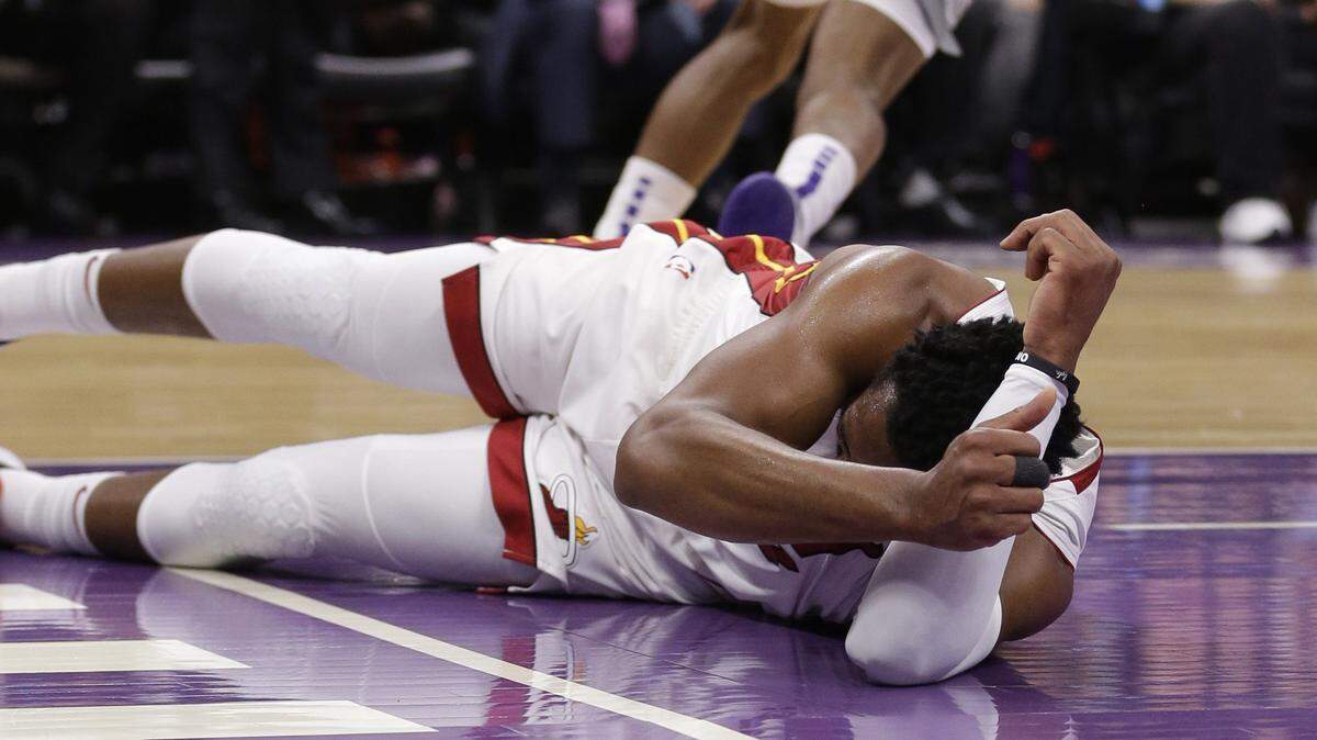 Miami Heat guard Dwyane Wade lies on the court after he hit his head following a hard landing during the first quarter of the team’s NBA basketball game against the Sacramento Kings. Friday, Feb. 8, 2019, in Sacramento, Calif. Wade left the game.