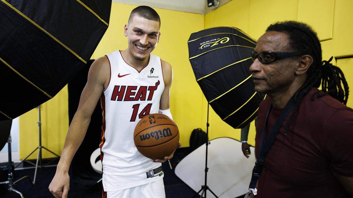 Tyler Herro (14) laughs after a portrait session with Miami Herald photographer Carl Juste, right, during the Miami Heat Media Day on Sept. 29, 2025, at Kaseya Center in Miami.