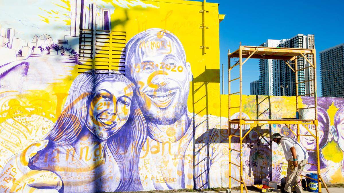 Artist Kyle Holbrook finishes his mural for mourners and fans of Kobe Bryant and his daughter Gianna so they can paint messages on the mural dedicated to the NBA legend in Miami’s historic Overtown community on Feb. 3, 2020.