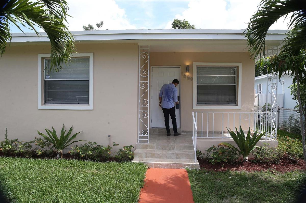 Real estate agent and developer Ivan Rabinovich shows a newly renovated home in the Liberty City/ Model City neighborhood that’s selling for $255,000.