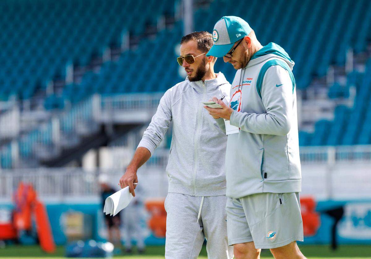 Miami Dolphins head coach Mike McDaniel talks with Dolphins quarterbacks coach / passing coordinator Darrell Bevell during practice at Baptist Health Training Complex in Hard Rock Stadium on Wednesday, December 28, 2022 in Miami Gardens, Florida.