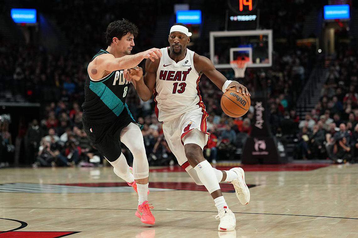 Bam Adebayo #13 of the Miami Heat dribbles against Deni Avdija #8 of the Portland Trail Blazers during the first half at Moda Center on January 22, 2026 in Portland.