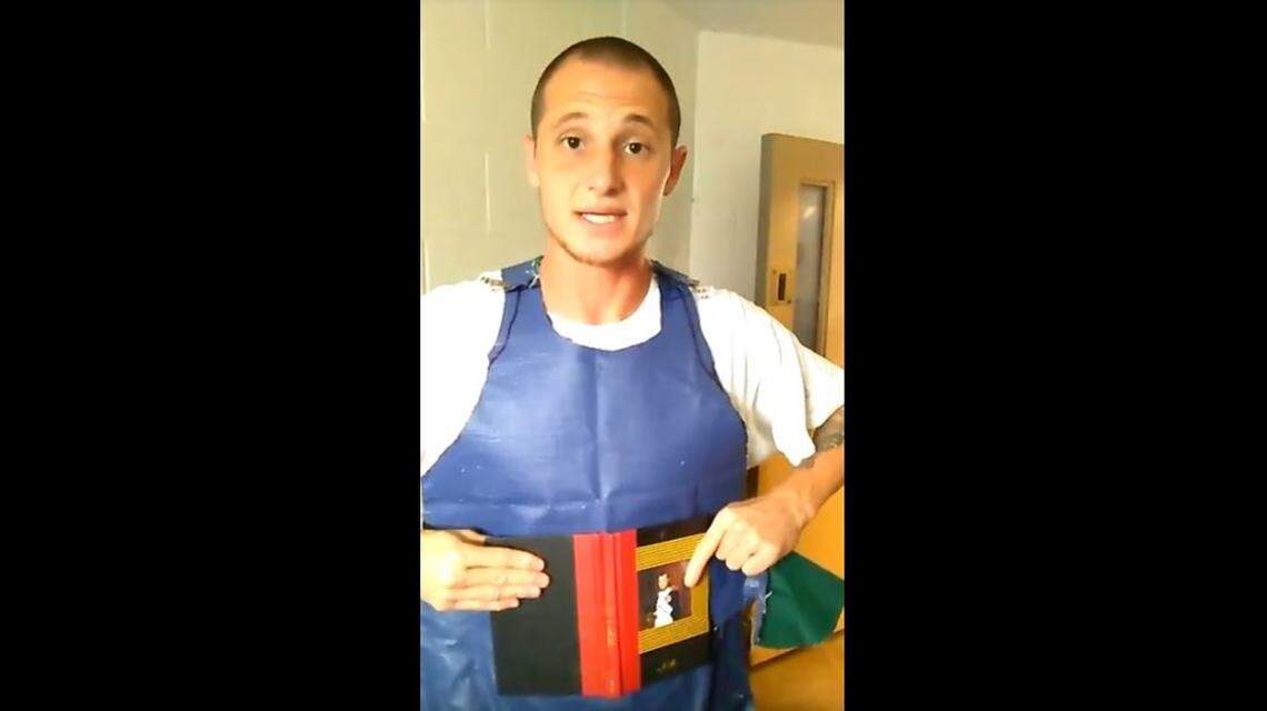 Scott Whitney, Florida inmate and furtive filmmaker, shows off his makeshift stab-proof vest.