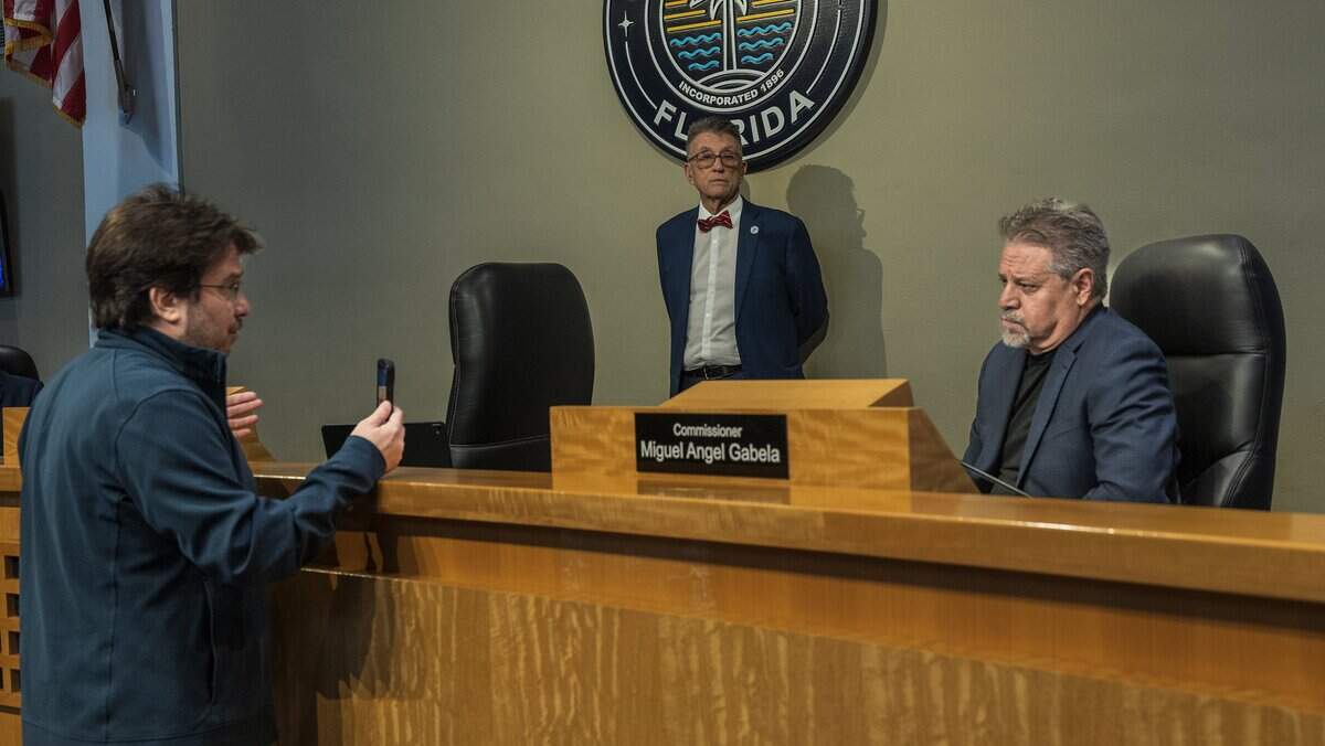 Resident Billy Corben (left) films as he asks questions to City of Miami Commissioner Miguel Angel Gabela, at the end of a Miami City Commission meeting, at City Hall, on Thursday May 28, 2026.