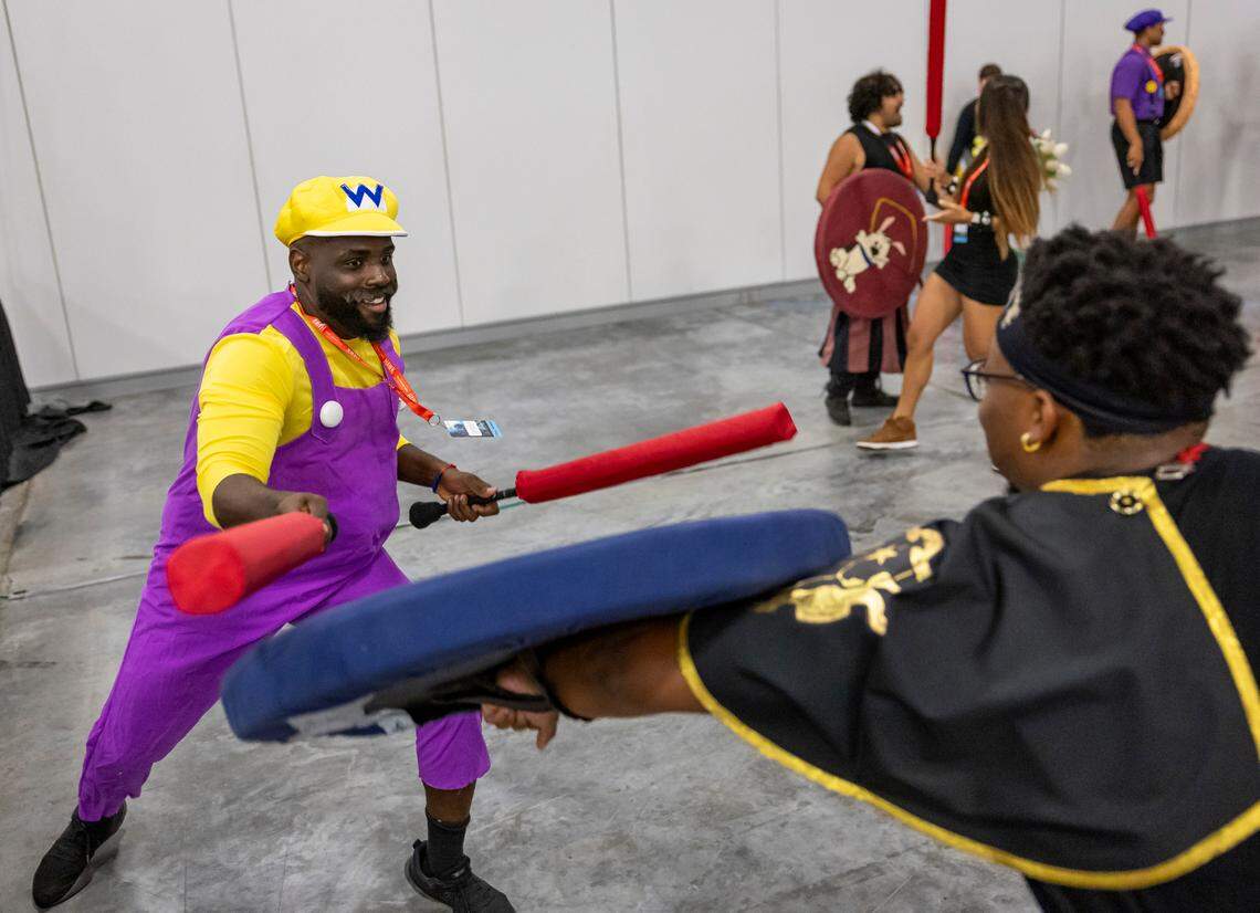 Nael Simonaire, 29, cosplaying as Wario from the Super Mario series, plays The Duchy of the Shifting Tides during Florida Supercon 2024 at the Miami Beach Convention Center on Saturday, July 13, 2024, in Miami Beach, Fla.