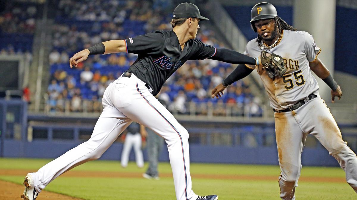 Miami Marlins third baseman Brian Anderson (15) tags out Pittsburgh Pirates first baseman Josh Bell (55) at third base in the fourth inning as the Miami Marlins host the Pittsburgh Pirates at Marlins Park on Saturday, June 15, 2019.