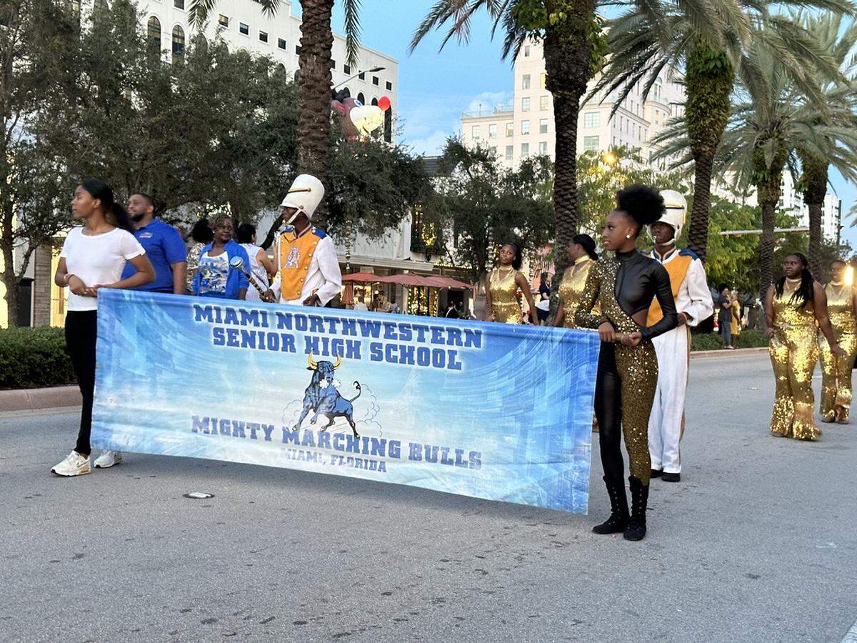 Miami Northwestern Senior High School’s Mighty Marching Bulls brings some Rockettes’-style flair and some musical pizzazz to the 75th Annual Junior Orange Bowl Parade on Miracle Mile in Coral Gables on Dec. 10, 2023.