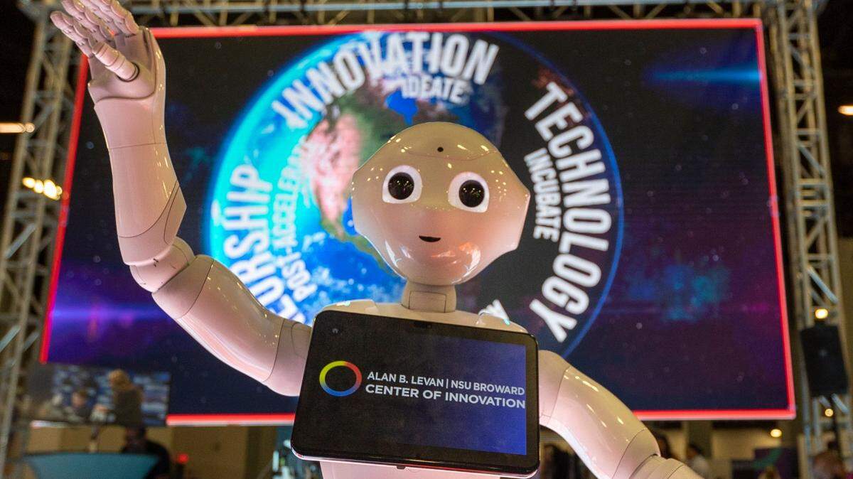 Pepper, a robot that assists visitors at the NSU Broward Center of Innovation, was on hand Thursday in Miami Beach Convention Center to greet eMerge Americas attendees.