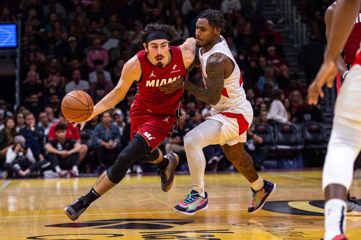 Miami Heat guard Jaime Jaquez Jr. (11) dribbles past Toronto Raptors guard Davion Mitchell (45) during the second half of an NBA game at Kaseya Center on Friday, Nov. 29, 2024, in Miami, Fla
