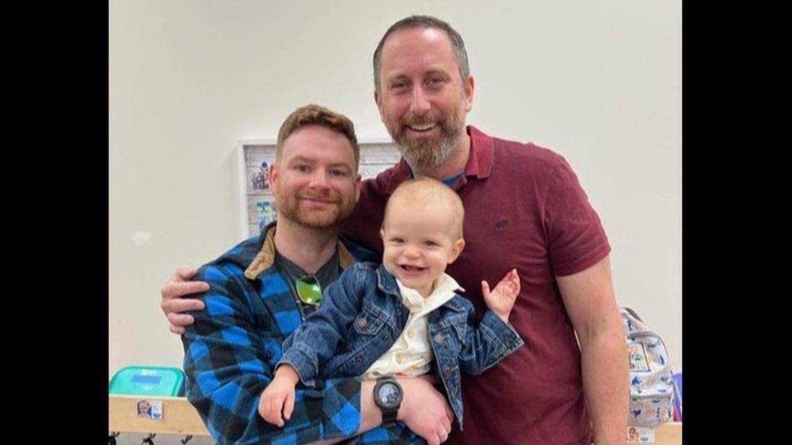 This provided photo shows Washington, D.C., Metropolitan Police Department Capt. Paul Hrebenak (right); his husband, James Fraser (left); and their son.