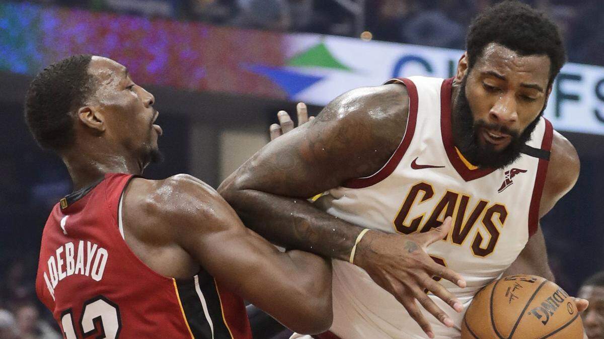 Cleveland Cavaliers’ Andre Drummond, right, drives past Miami Heat’s Bam Adebayo in the first half of an NBA basketball game, Monday, Feb. 24, 2020, in Cleveland.