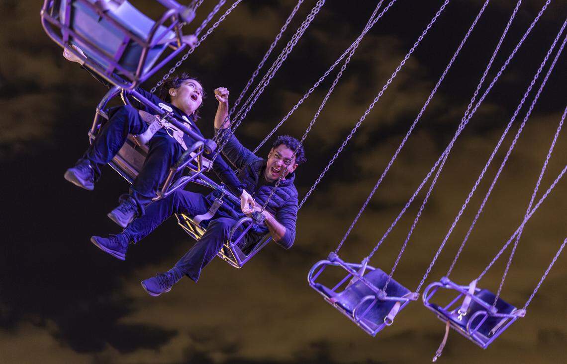 Harold Bernate and his son, Alec Bernate, 9, enjoy a ride during the grand opening of Ripley's Believe It or Not! Christmas Park at Amelia Earhart Park on Thursday, Nov. 13, 2025, in Hialeah, Fla.