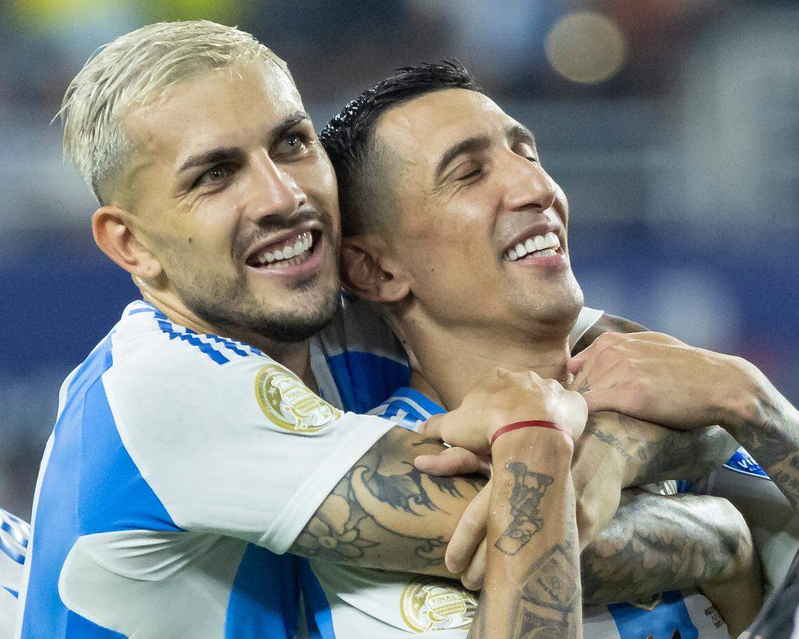 Argentina midfielder Leandro Paredes (5) hugs forward Ángel Di Maria (11) after they defeated Colombia in their Copa America 2024 Final soccer match at Hard Rock Stadium on Sunday, July 14, 2024, in Miami Gardens, Fla.