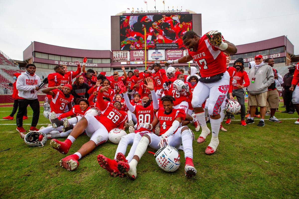 Cardinal Gibbons varsity football team celebrates in the middle of the field after defeating Jacksonville Bolles during the 4A State Championship at Doak Campbell Stadium in Tallahassee, Florida, on Thursday, December 17, 2020. The Chiefs were victorious over the Bulldogs 35-21.