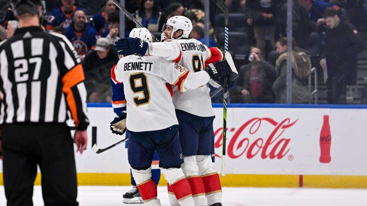 Jan 27, 2024; Elmont, New York, USA; Florida Panthers center Sam Bennett (9) celebrates the game winning goal by Florida Panthers defenseman Oliver Ekman-Larsson (91) against the New York Islanders during overtime at UBS Arena.