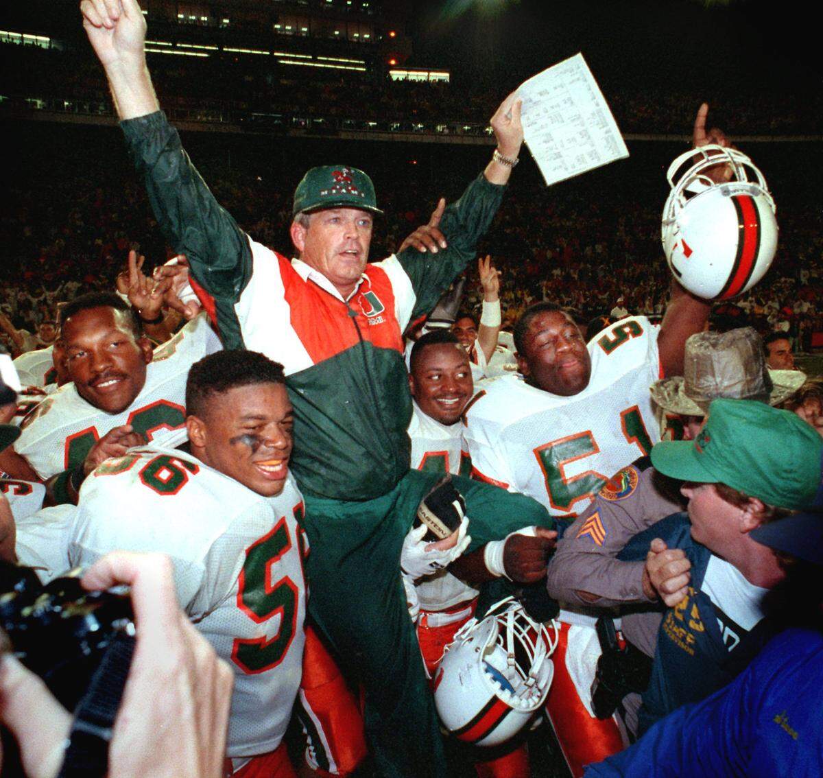 University of Miami head coach Dennis Erickson is lifted on his players shoulders after guiding The Hurricanes to a national championship in the Orange Bowl. (1991 season championship)