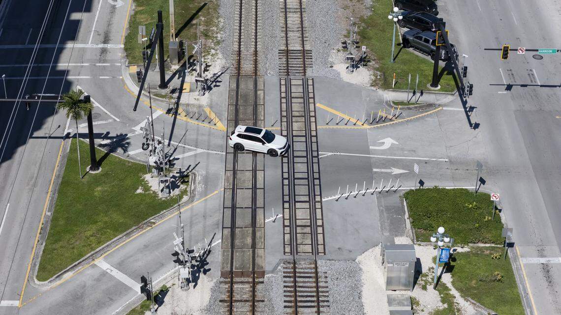 An SUV drives across train tracks at the Harrison Street rail crossing in Hollywood, Florida.