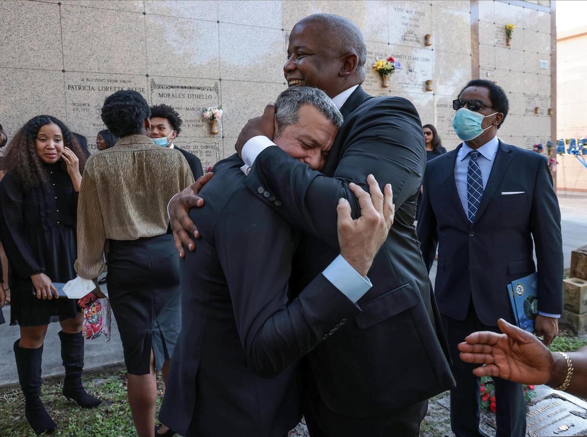 On Tuesday, December 7, 2021 Kendrick Meek embraces his close friend Alex Fernandez, as relatives and friends bid their final goodbyes as the casket of Carrie P. Meek was placed inside the burial vault at Caballero Rivero Dade North in Opa-Locka, Florida.