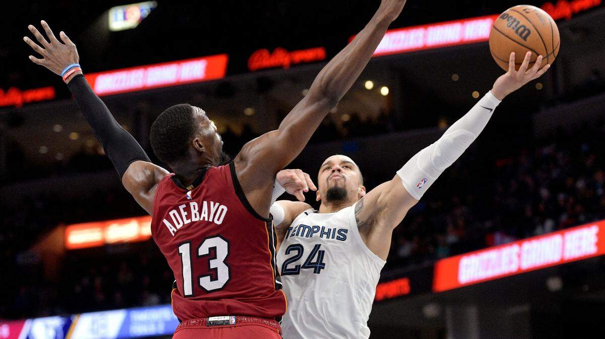 Memphis Grizzlies forward Dillon Brooks (24) shoots the ball against Miami Heat center Bam Adebayo (13) in the first half of an NBA basketball game, Monday, Dec. 5, 2022, in Memphis, Tenn.
