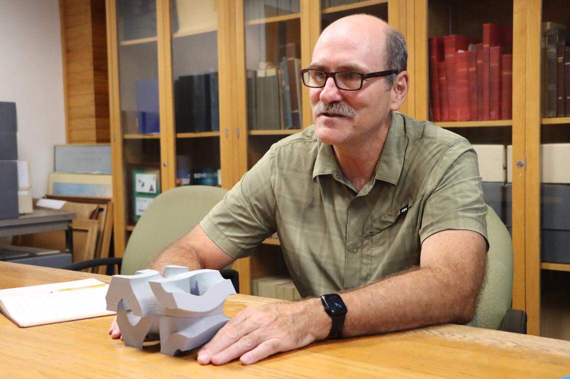 Michael Yukish, a Penn State aerospace engineering professor, with a model of the gyroid lattices. The gyroid shaped concrete is the second layer of the hybrid reef.