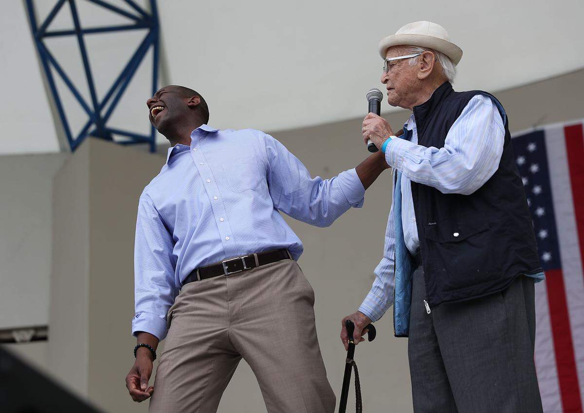 Florida Democratic governor candidate Andrew Gillum (R) shares a laugh with Norman Lear during  a Get Out the Vote rally at the Meyer Amphitheatre on November 3, 2018 in West Palm Beach, Florida.