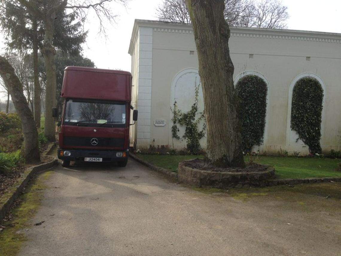 A police truck is parked next to the squash court where the La Hougue records were stored.