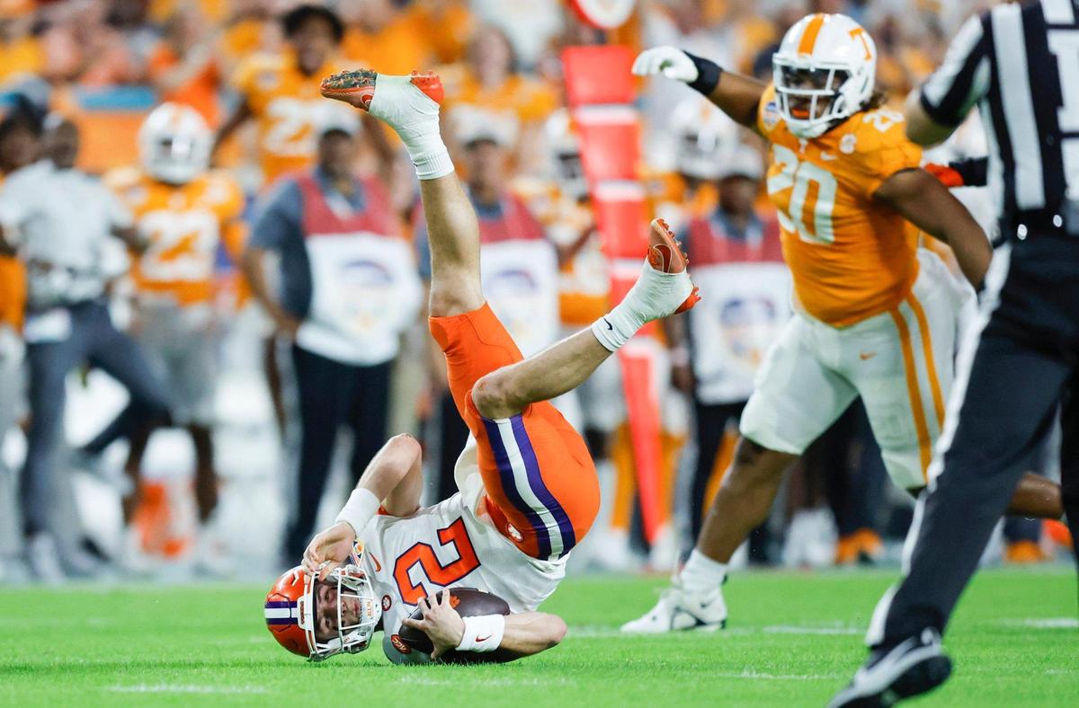 Clemson Tigers quarterback Cade Klubnik (2) is upended on a sack in the first half by Tennessee Volunteers linebacker Aaron Beasley (24) at Hard Rock Stadium in Miami Gardens, Florida on Friday, December 30, 2022.