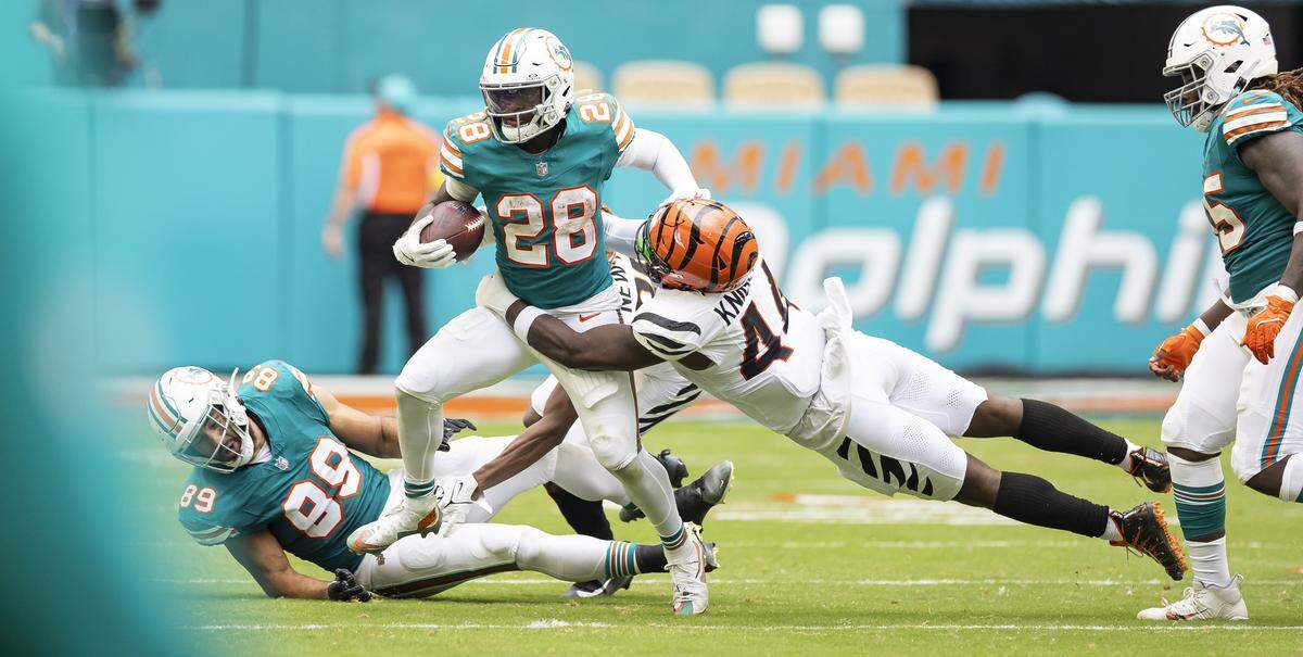 Cincinnati Bengals linebacker Demetrius Knight Jr. (44) tackles Miami Dolphins running back De'Von Achane (28) in the second half of their NFL game at Hard Rock Stadium on Sunday, Dec. 21, 2025, in Miami Gardens, Fla.