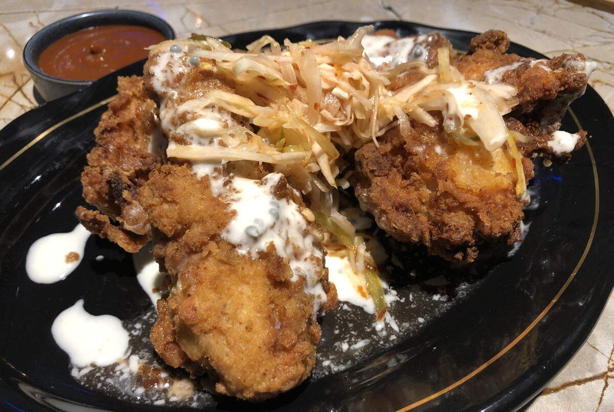 Ember’s smoked fried chicken with caviar butter, topped with spicy pickled shredded vegetables, a version of Haitian pikliz